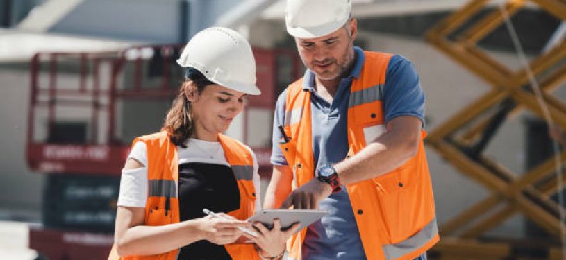 Civil Engineers Checking Works According To Project Using Digital Tablet At Construction Site